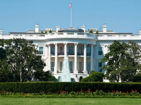 The White House with fountain and flag.