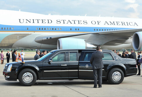 Presidential limousine parked in front of Air Force One at an airport