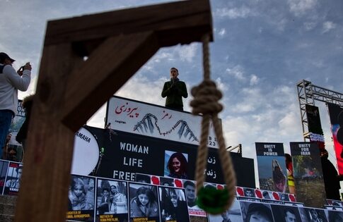 A protest scene with a speaker and a noose symbolizing oppression