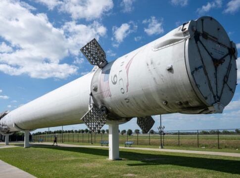 Falcon 9 first stage booster displayed outdoors on support stands